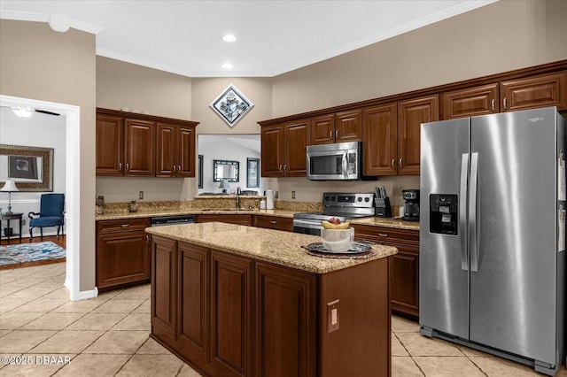 kitchen featuring light tile patterned flooring, appliances with stainless steel finishes, a kitchen island, and sink