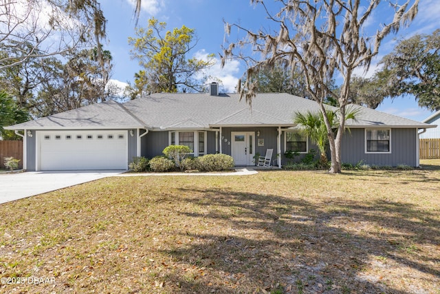 ranch-style house with a garage and a front lawn