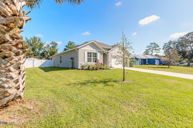 ranch-style home with a front lawn