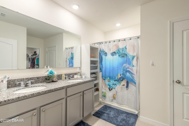 bathroom with vanity, tile patterned floors, and shower / tub combo