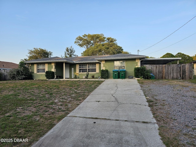 2519 Eustace Ave, Deltona, FL 32725 - ranch-style home with stucco siding, concrete driveway, and an attached carport