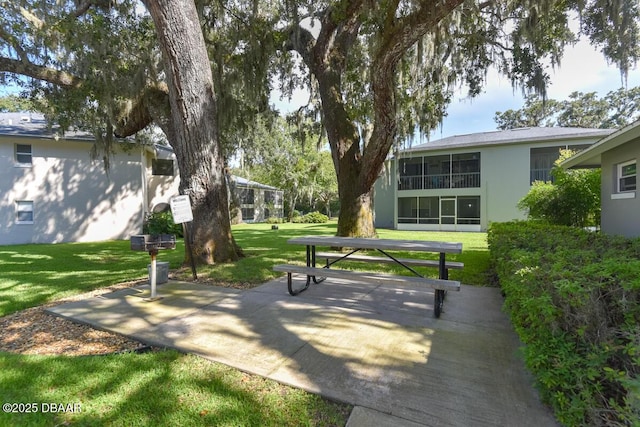 203 S Orchard St Unit 5C, Ormond Beach, FL 32174 - view of community featuring a yard and a patio area