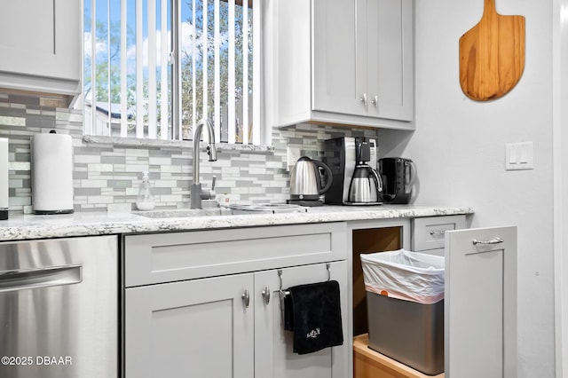 bar with a sink, dishwasher, and tasteful backsplash