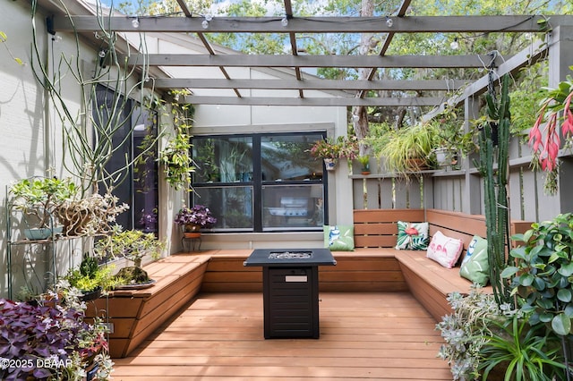 wooden terrace with a pergola and a fire pit
