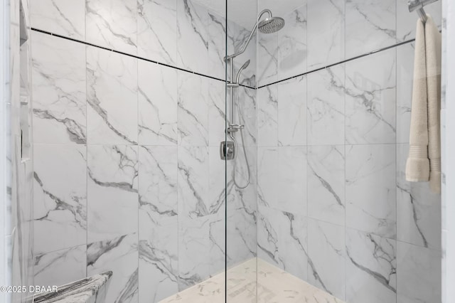 bathroom with a marble finish shower