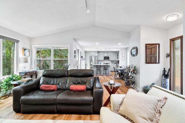 living room with light wood finished floors and lofted ceiling