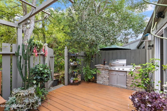 wooden deck featuring a grill, fence, and area for grilling