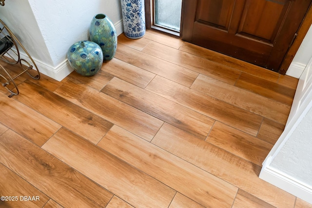 room details with baseboards and wood finished floors