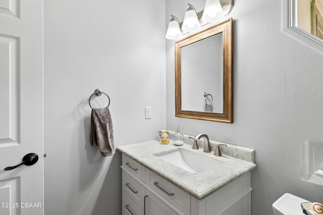half bathroom featuring toilet and vanity