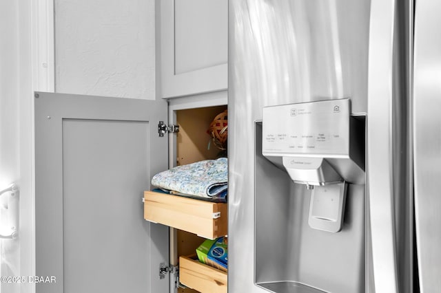 interior details featuring stainless steel fridge with ice dispenser
