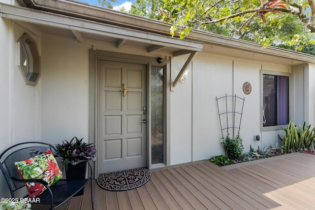 doorway to property featuring stucco siding