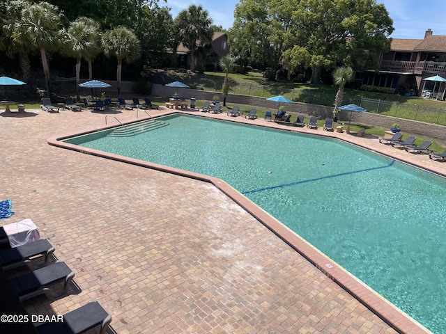 community pool featuring a patio area and fence