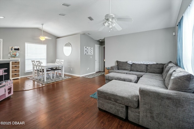 living room featuring ceiling fan, vaulted ceiling, and dark hardwood / wood-style flooring