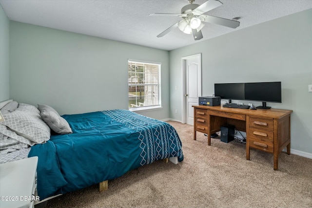 bedroom with a textured ceiling, ceiling fan, and light colored carpet