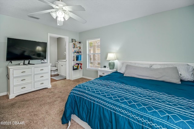 carpeted bedroom featuring ceiling fan and ensuite bath