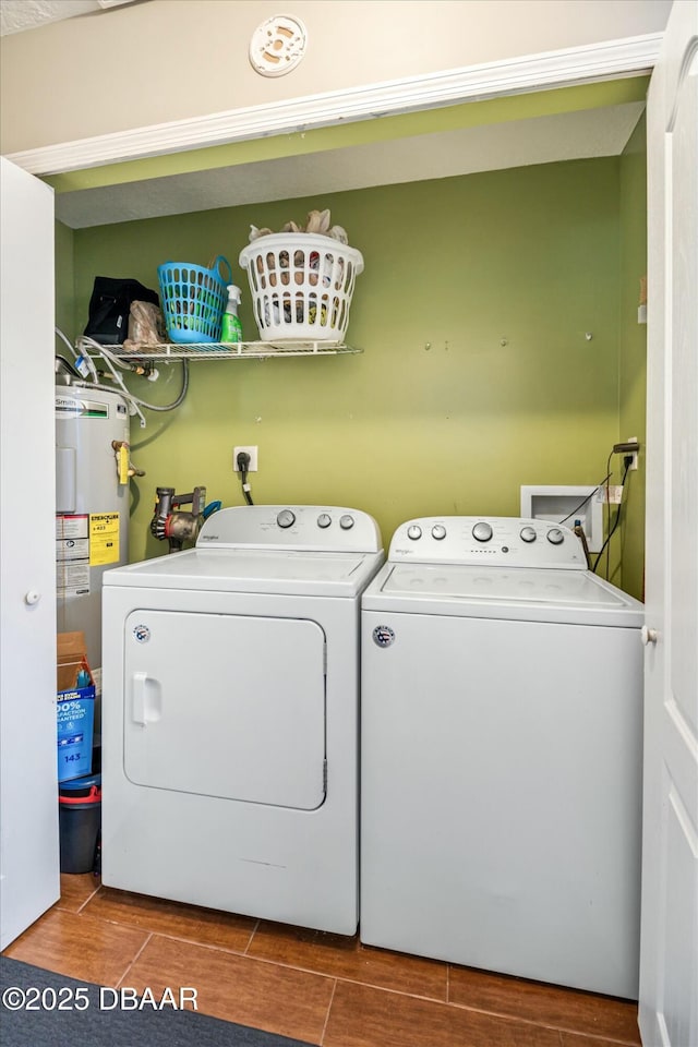 washroom featuring electric water heater and washing machine and dryer