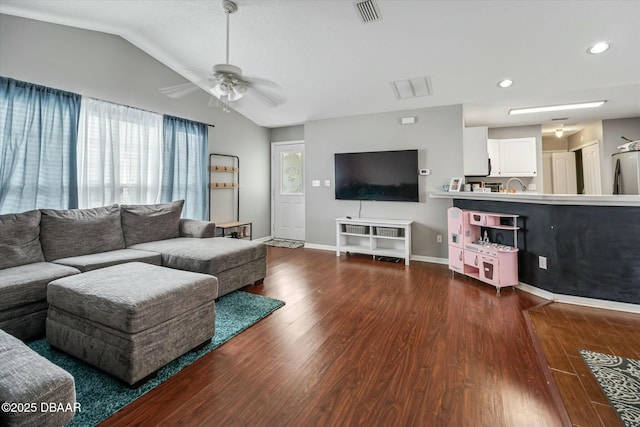 living room featuring ceiling fan, dark wood-type flooring, and lofted ceiling