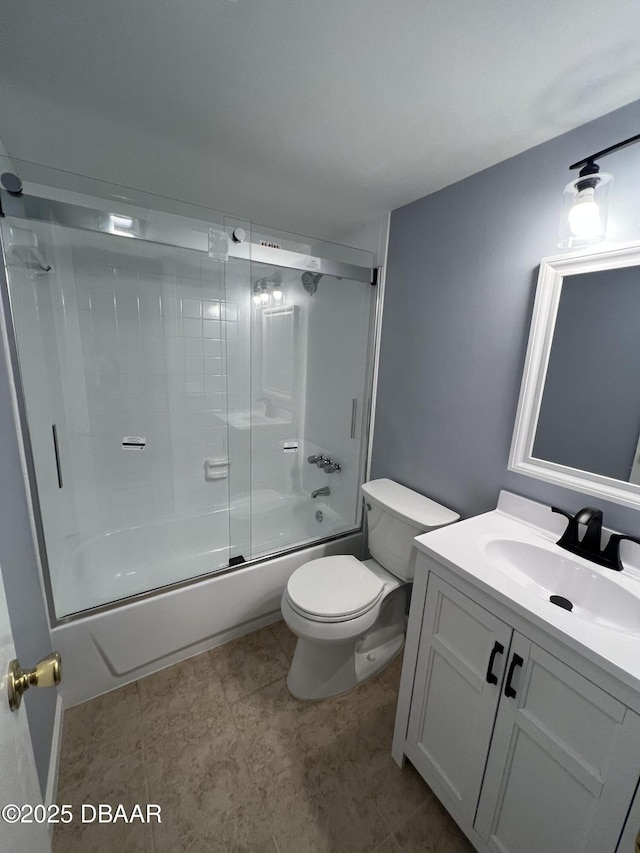 full bathroom with vanity, bath / shower combo with glass door, and toilet