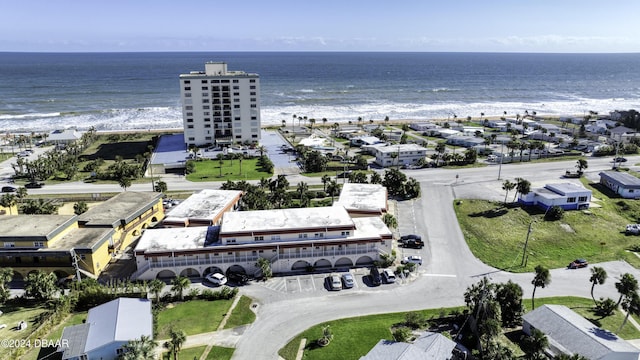 drone / aerial view with a beach view and a water view