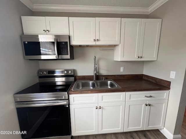 kitchen featuring white cabinets, crown molding, sink, and appliances with stainless steel finishes