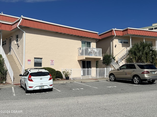 1510 Ocean Shore Blvd Unit 3120, Ormond Beach, FL 32176 - view of property with stairway and uncovered parking