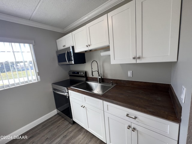 kitchen featuring white cabinets, sink, ornamental molding, dark hardwood / wood-style flooring, and stainless steel appliances