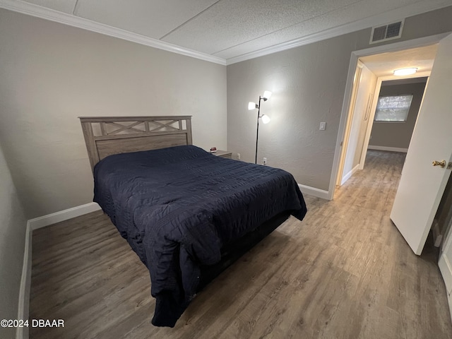 1510 Ocean Shore Blvd Unit 3120, Ormond Beach, FL 32176 - bedroom with ornamental molding, light wood-style flooring, baseboards, and a textured ceiling