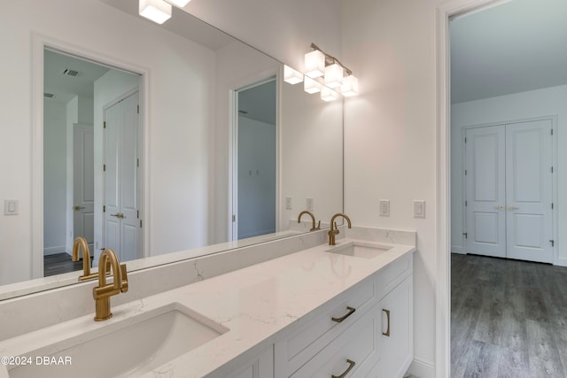 bathroom with hardwood / wood-style floors and vanity