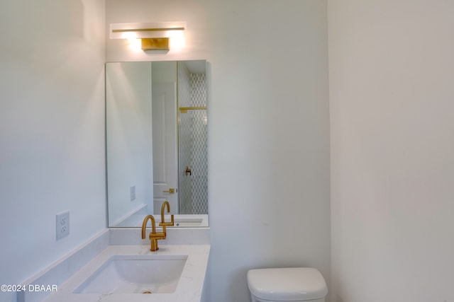 bathroom featuring toilet and vanity