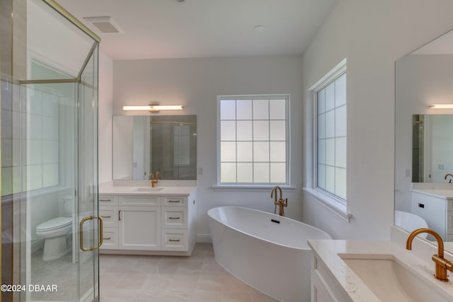 full bathroom featuring toilet, shower with separate bathtub, and vanity