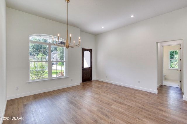 interior space featuring light wood-type flooring and a chandelier