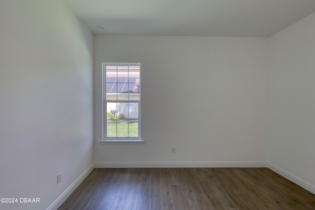 empty room with dark hardwood / wood-style flooring