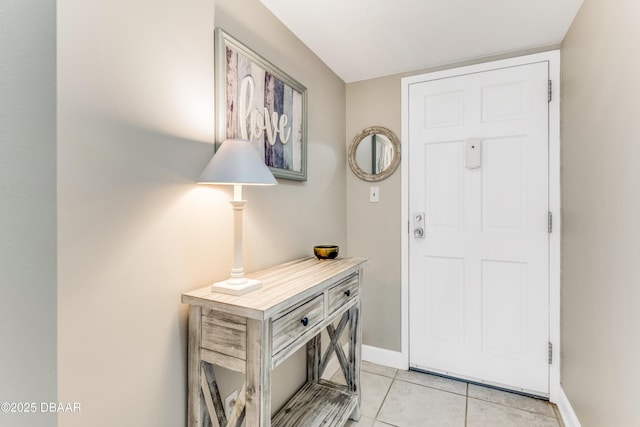 entryway featuring light tile patterned floors and baseboards