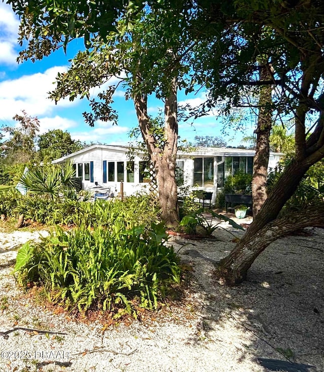 view of front of home featuring a sunroom