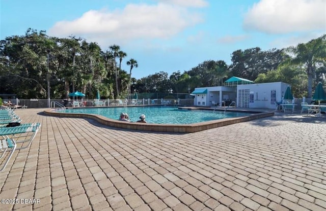 community pool featuring fence and a patio