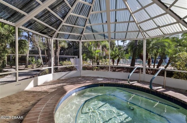 view of swimming pool featuring a hot tub