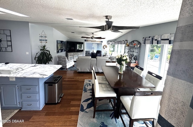 dining space featuring a healthy amount of sunlight, ceiling fan, visible vents, and dark wood-style flooring