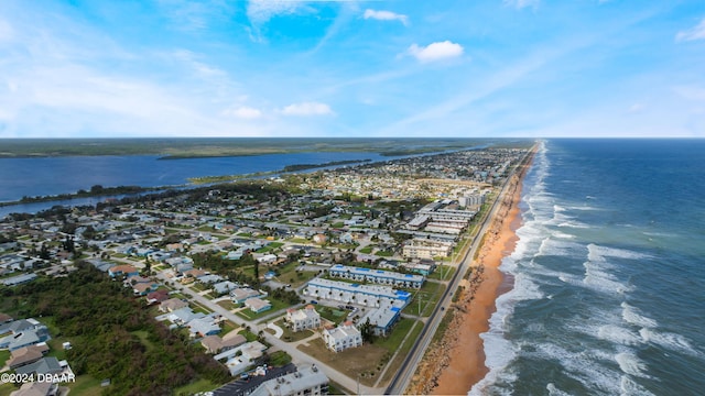 bird's eye view with a water view and a beach view