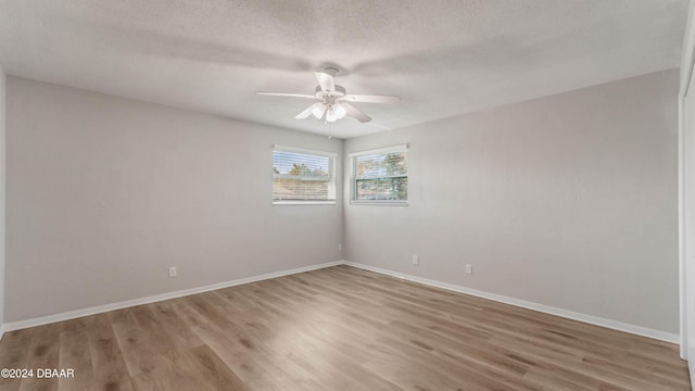 empty room with wood-type flooring, a textured ceiling, and ceiling fan