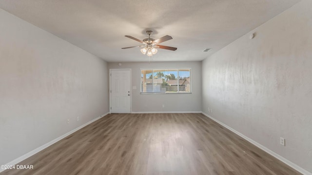 spare room with hardwood / wood-style floors and ceiling fan