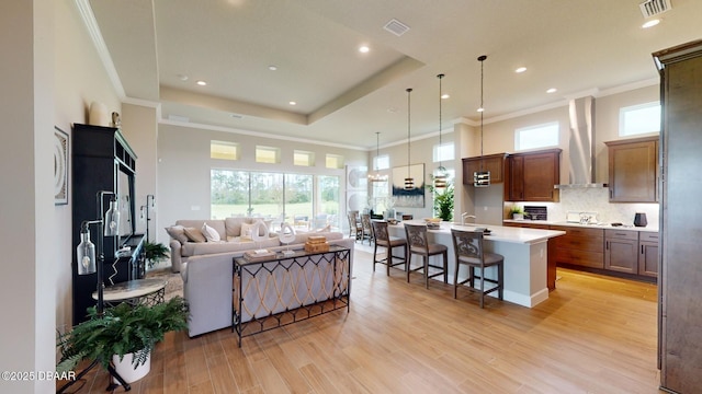 191 Aspen Way, Palm Coast, FL 32137 - living area with light wood finished floors, crown molding, recessed lighting, plenty of natural light, and a towering ceiling