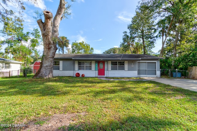 ranch-style house featuring a garage and a front yard