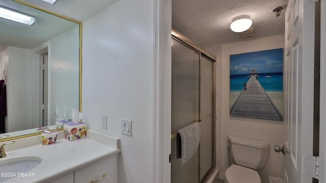 bathroom with walk in shower, vanity, a textured ceiling, and toilet