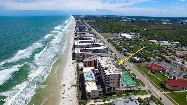 drone / aerial view featuring a water view and a beach view