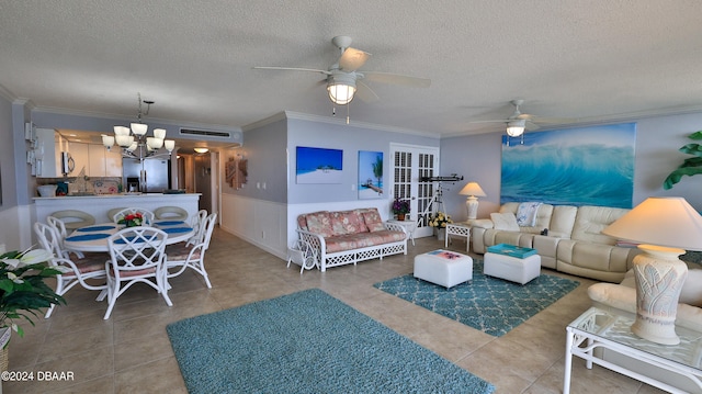 tiled living room featuring ceiling fan with notable chandelier, a textured ceiling, and crown molding