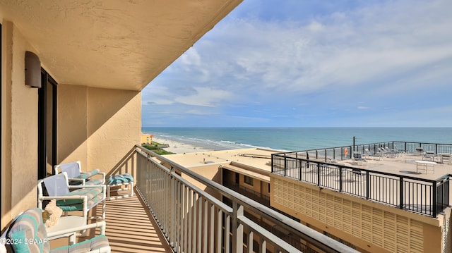 balcony with a beach view and a water view