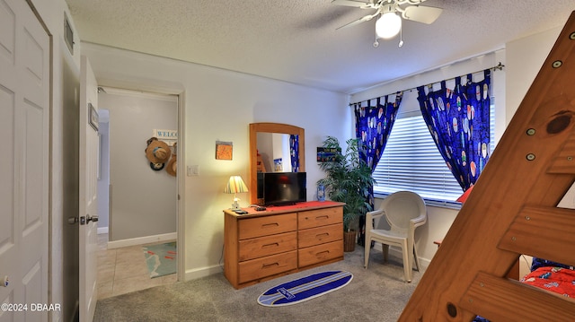 carpeted bedroom featuring a textured ceiling and ceiling fan