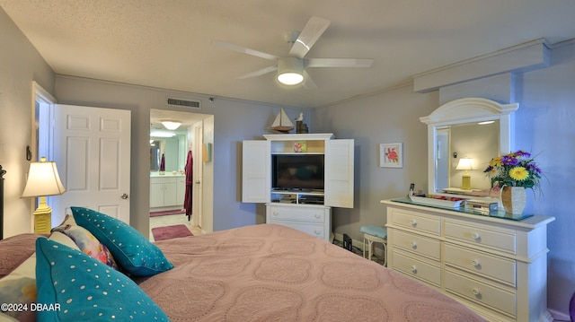 bedroom featuring ensuite bathroom, ceiling fan, and a textured ceiling