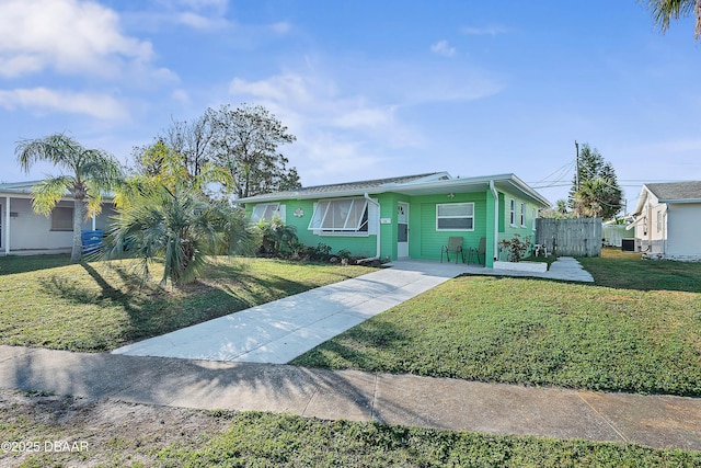 ranch-style home featuring a front lawn and central air condition unit