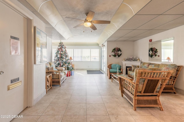 tiled living room featuring ceiling fan